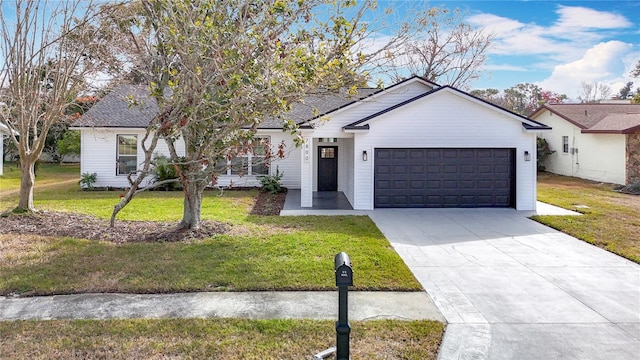 view of front of property with a garage and a front yard