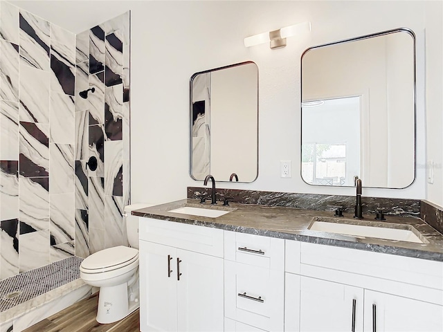 bathroom featuring vanity, wood-type flooring, curtained shower, and toilet