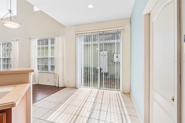 entryway featuring lofted ceiling and light tile patterned floors