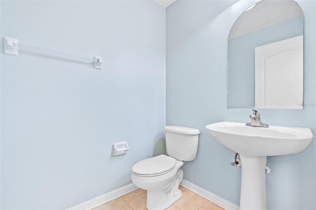 bathroom featuring sink, tile patterned floors, and toilet