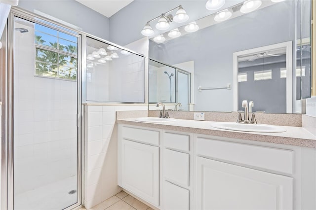 bathroom with an enclosed shower, vanity, and tile patterned floors