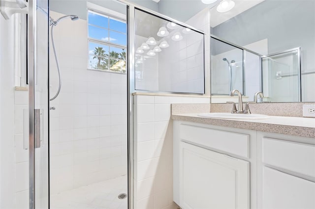 bathroom with vanity and a shower with shower door