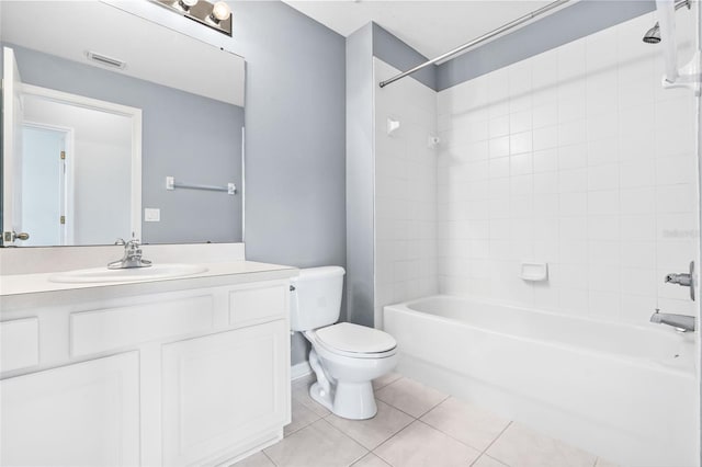 full bathroom featuring vanity, toilet, tiled shower / bath combo, and tile patterned flooring