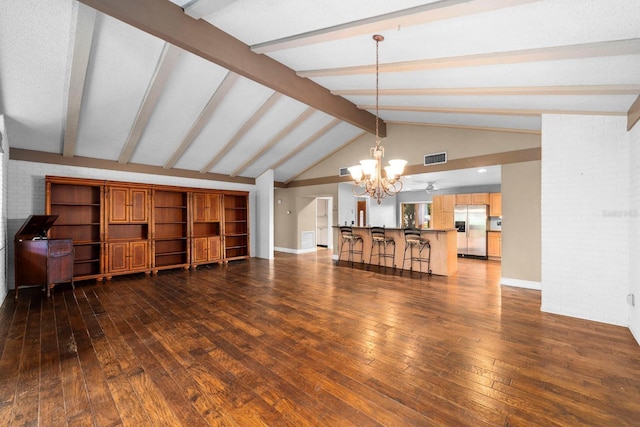 living room with brick wall, dark wood-type flooring, vaulted ceiling with beams, and a chandelier