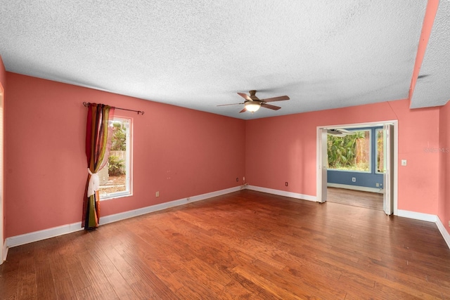 unfurnished room featuring ceiling fan, dark hardwood / wood-style floors, and a textured ceiling