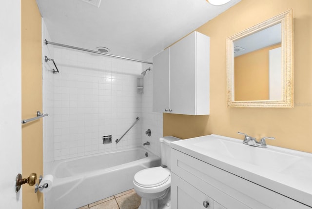 full bathroom featuring tile patterned flooring, vanity, tiled shower / bath, and toilet