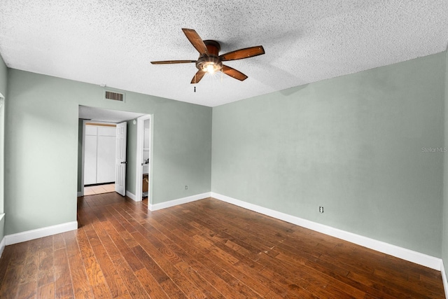 unfurnished room featuring ceiling fan, dark hardwood / wood-style floors, and a textured ceiling