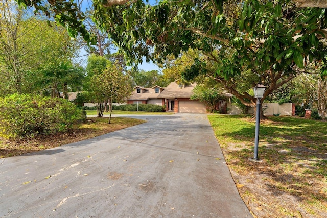 view of front facade with a garage and a front lawn