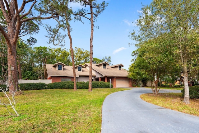 view of front of house with a garage and a front yard