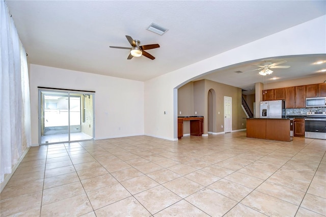 interior space featuring light tile patterned flooring and ceiling fan