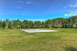 surrounding community with a yard and volleyball court