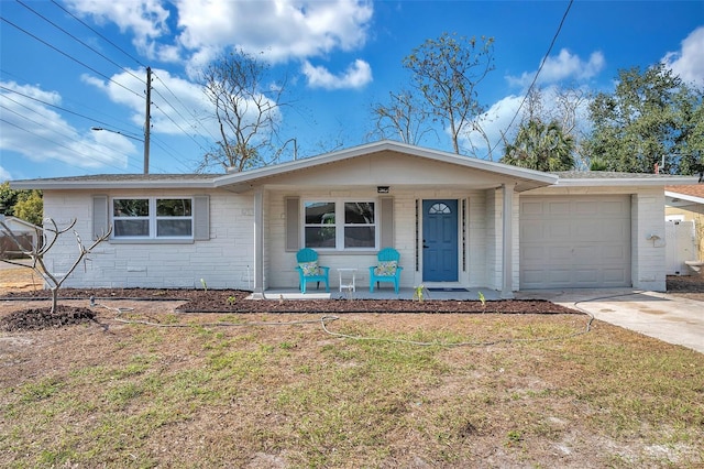 single story home with a porch, a garage, and a front lawn