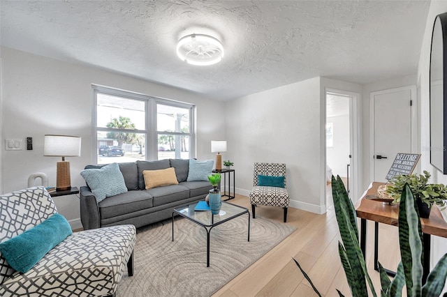 living room featuring light hardwood / wood-style floors and a textured ceiling