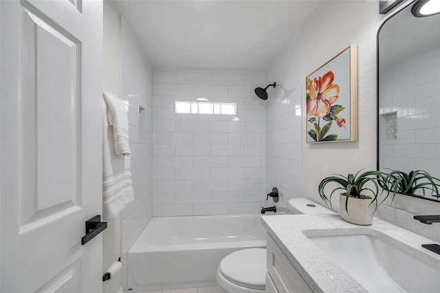 full bathroom with vanity, tiled shower / bath, and toilet