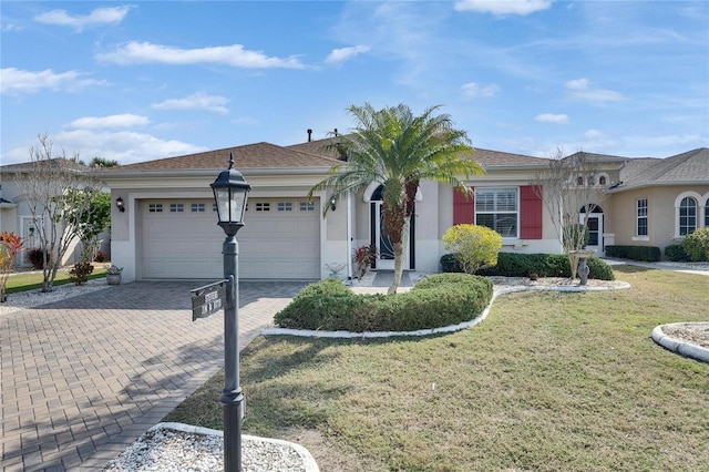 single story home featuring a garage and a front lawn