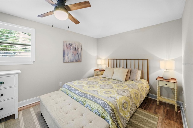 bedroom with wood finished floors, a ceiling fan, and baseboards