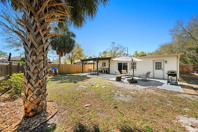 back of property featuring a fenced backyard and a patio