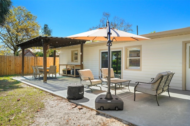 view of patio with fence and a pergola