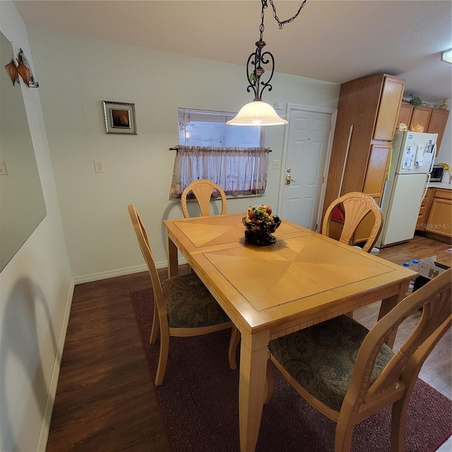 dining area with dark wood-type flooring