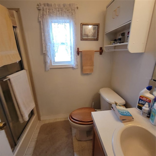 bathroom with vanity, toilet, and an enclosed shower