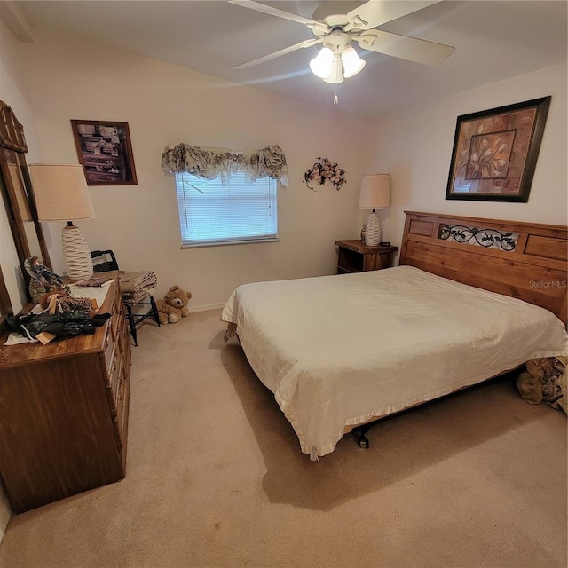 bedroom featuring light carpet and ceiling fan