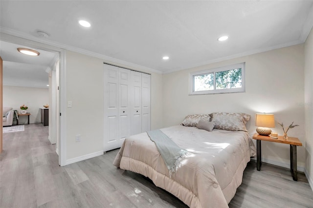 bedroom featuring crown molding, a closet, and light hardwood / wood-style flooring