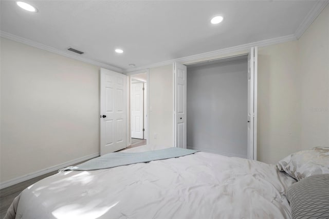 bedroom with ornamental molding and a closet