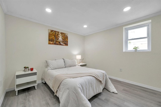 bedroom with ornamental molding and hardwood / wood-style floors