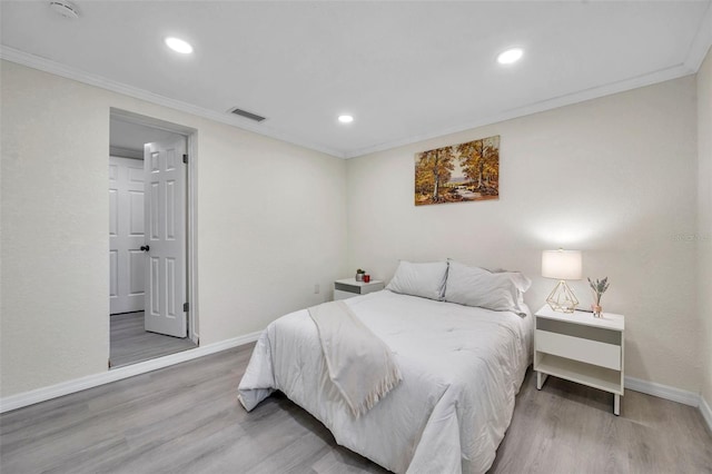 bedroom with ornamental molding and wood-type flooring