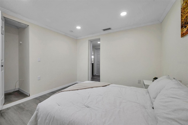 bedroom featuring hardwood / wood-style flooring and crown molding