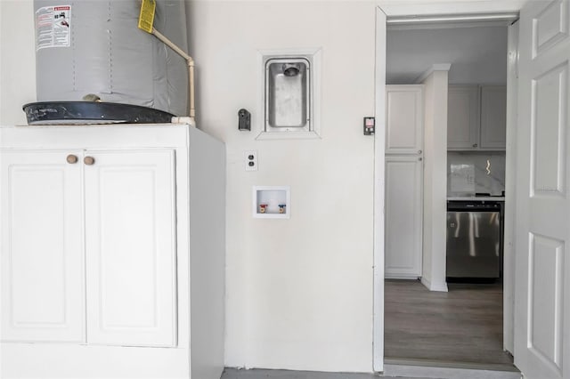 clothes washing area with water heater, hardwood / wood-style floors, hookup for a washing machine, and cabinets