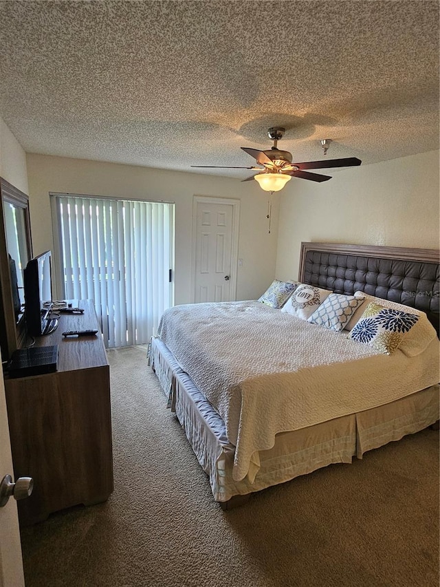 carpeted bedroom featuring ceiling fan and a textured ceiling