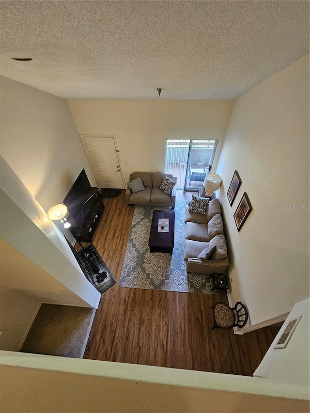 living room featuring hardwood / wood-style flooring and a textured ceiling