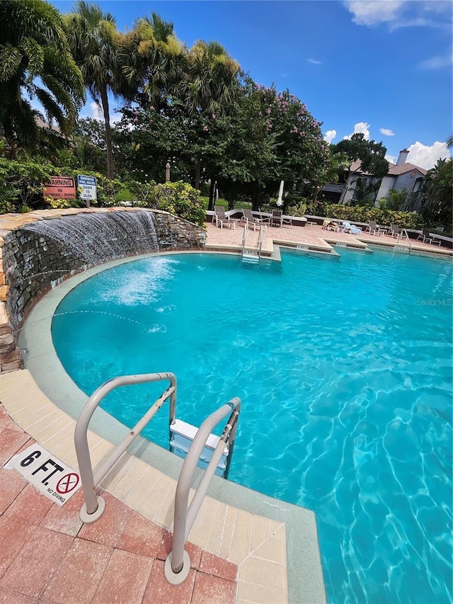 view of pool with pool water feature