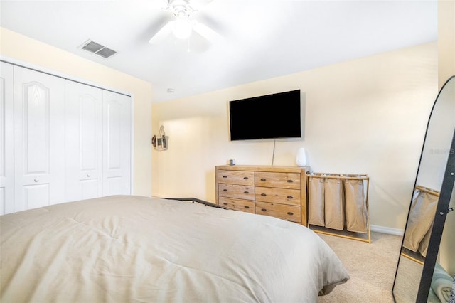 carpeted bedroom with ceiling fan and a closet