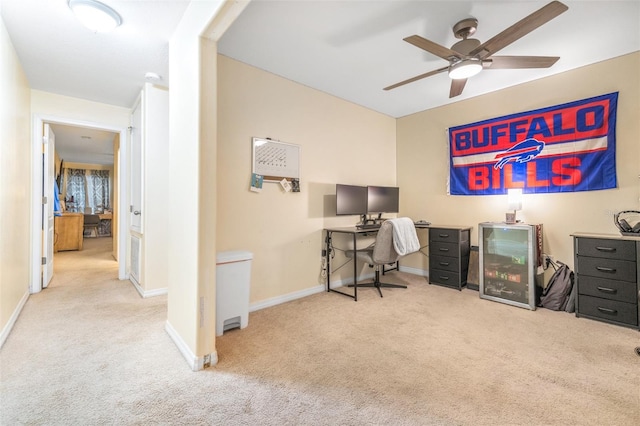 home office featuring light carpet and ceiling fan