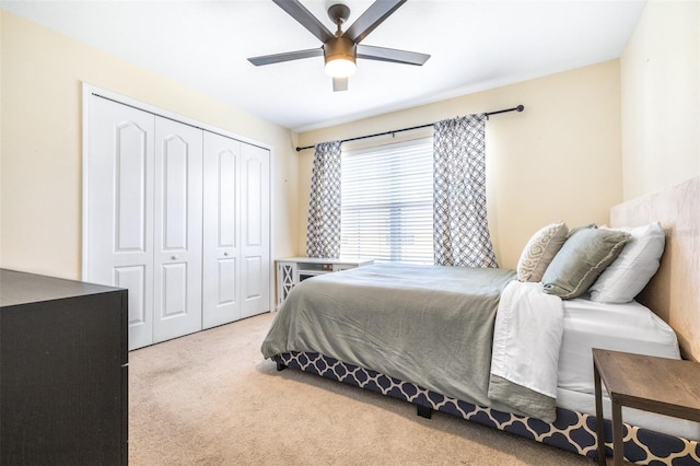 bedroom with ceiling fan, carpet flooring, and a closet