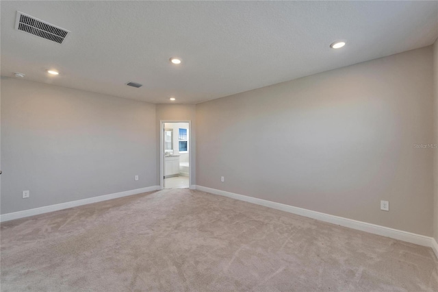 empty room featuring light carpet