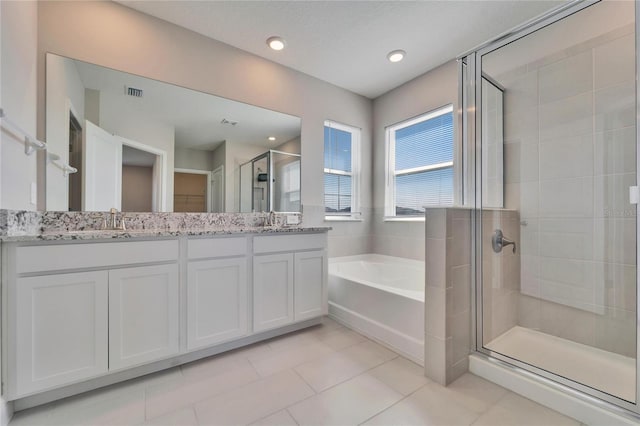 bathroom featuring tile patterned floors, separate shower and tub, and vanity