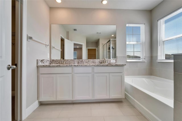 bathroom with vanity, separate shower and tub, and a healthy amount of sunlight