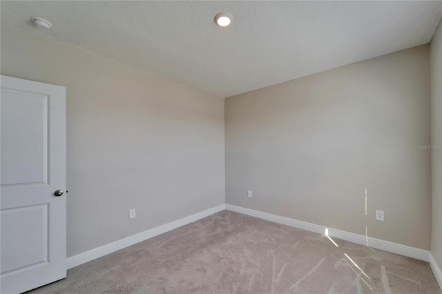 empty room featuring light carpet