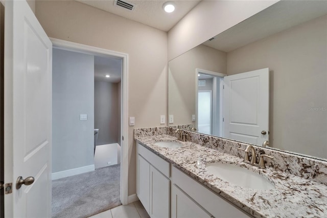 bathroom featuring vanity, tile patterned flooring, and a textured ceiling