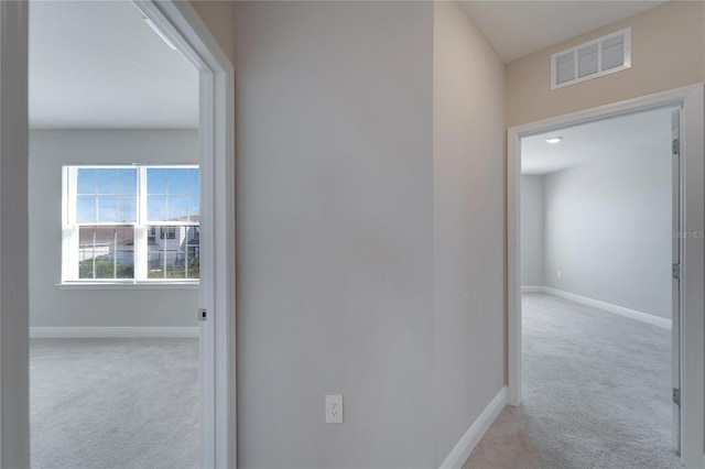 corridor with light colored carpet