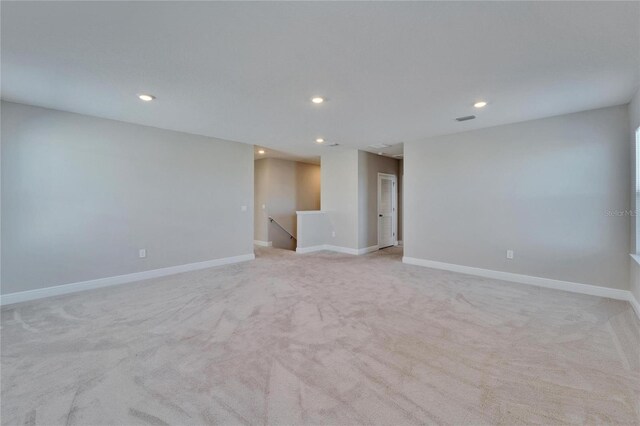 unfurnished room with light colored carpet