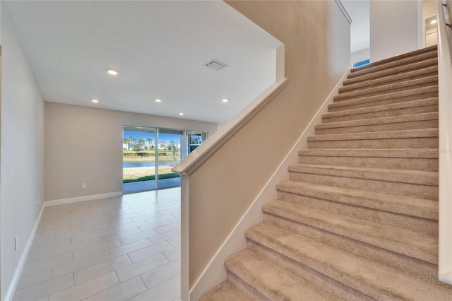 stairs with tile patterned floors