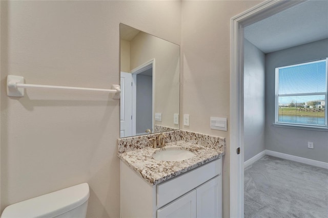 bathroom featuring vanity, a water view, and toilet