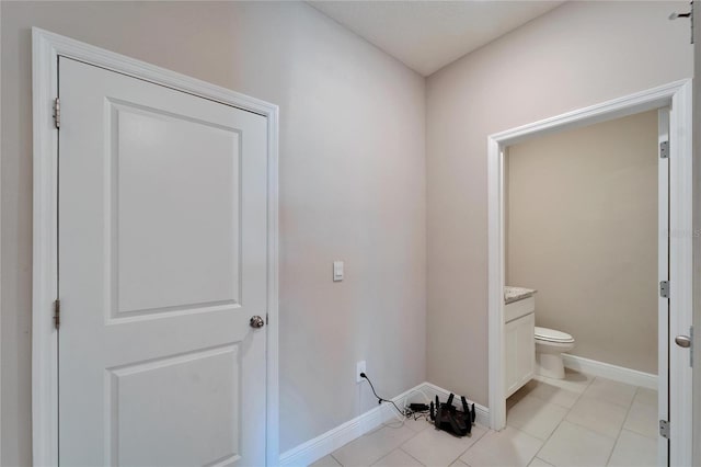 bathroom with tile patterned flooring, vanity, and toilet