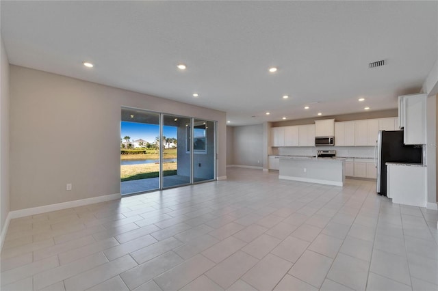 unfurnished living room featuring light tile patterned flooring