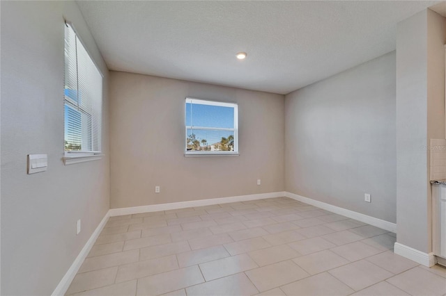 unfurnished room with a healthy amount of sunlight and a textured ceiling