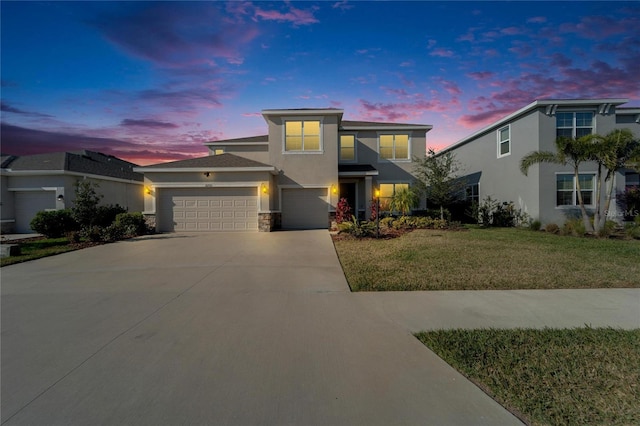 view of front of property with a garage and a yard